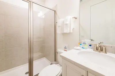 a bathroom with a shower and a toilet and a sink at Vibrant Cottage Near Disney With Margaritaville Resort & Island H20 Waterpark Access- 3000Sp in Orlando