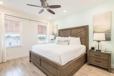 a bedroom with a large bed and a ceiling fan at Vibrant Cottage Near Disney With Margaritaville Resort & Island H20 Waterpark Access- 3000Sp in Orlando