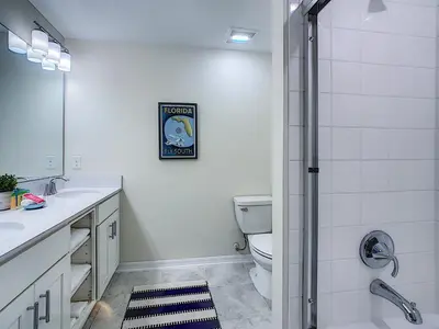 a bathroom with a toilet and a sink and a shower at Updated Condo, 5 mi to Disney, On-site Water Park in Kissimmee