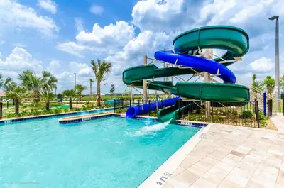 a water slide in a pool at a resort at Updated Condo, 5 mi to Disney, On-site Water Park in Kissimmee