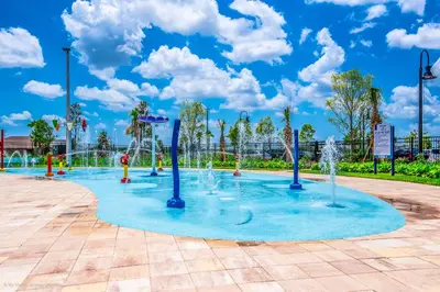 a playground with water fountains in a park at Updated Condo, 5 mi to Disney, On-site Water Park in Kissimmee