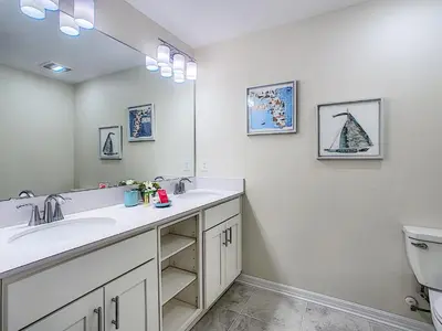 a bathroom with a sink and a toilet and a mirror at 3150 Paradox Circle 107 in Kissimmee