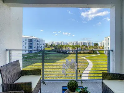 a balcony with a view of a city at Modern Condo near Disney Foosball Water Park in Kissimmee