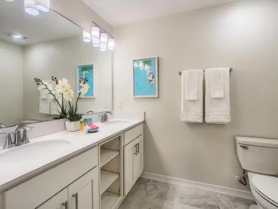 a bathroom with two sinks and a toilet at Modern Condo near Disney Foosball Water Park in Kissimmee
