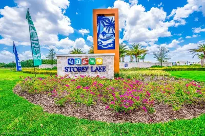 a sign for a store in a park with flowers at Modern Condo near Disney Foosball Water Park in Kissimmee