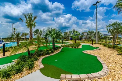 a miniature golf course at the resort with palm trees at Modern Condo near Disney Foosball Water Park in Kissimmee