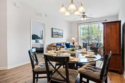 a dining room and living room with a table and chairs at Renovated Condo by Convention Center & I-Drive in Orlando
