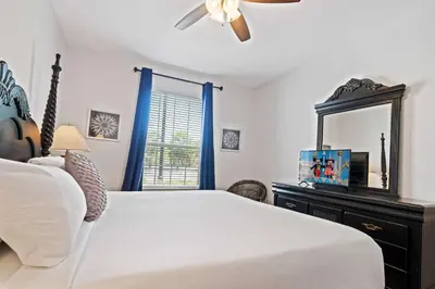 a bedroom with a white bed and a mirror at Renovated Condo by Convention Center & I-Drive in Orlando