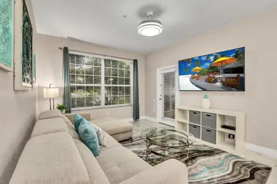 a living room with a couch and a glass table at 7664 Comrow Street #104 in Orlando