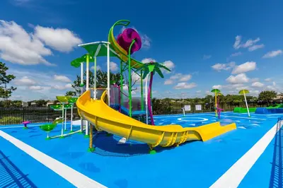 a playground with a slide in a swimming pool at 7664 Comrow Street #104 in Orlando