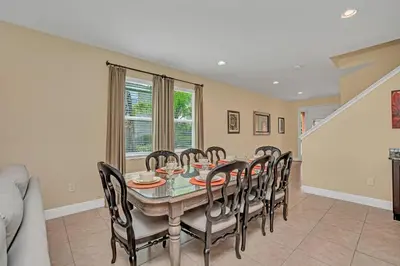 a dining room with a table and chairs at Modern Villa wPrivate Pool and Air Hockey Table in Orlando