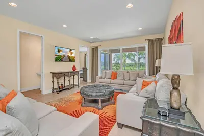 a living room with a white couch and a table at Modern Villa wPrivate Pool and Air Hockey Table in Orlando