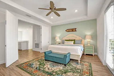 a bedroom with a bed and a ceiling fan at Large Margaritaville Villa w PRIVATE POOL View in Orlando