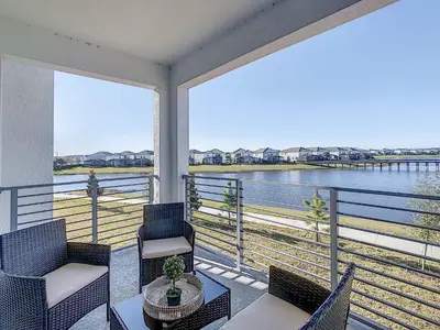 a balcony with chairs and a view of the water at 3131 Paradox Cir Unit 203 in Kissimmee