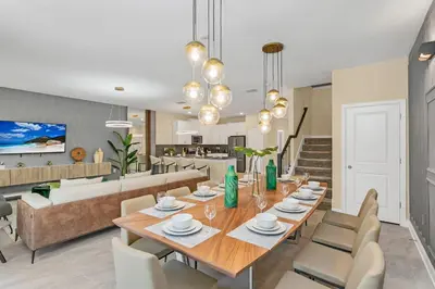a dining room and living room with a table and chairs at 4520 Target Blvd in Kissimmee