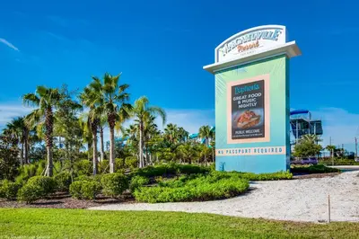 a sign at the entrance to a resort with palm trees at Gorgeous Margaritaville Cottage wPrivate Patio in Orlando