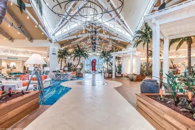 a lobby with palm trees and a chandelier at Gorgeous Margaritaville Cottage wPrivate Patio in Orlando