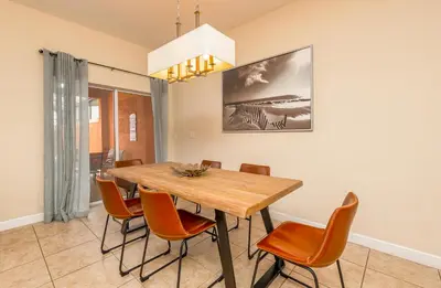a dining room with a wooden table and chairs at Spetacular TownHome With Private Pool close to Disney 8919PP in Kissimmee