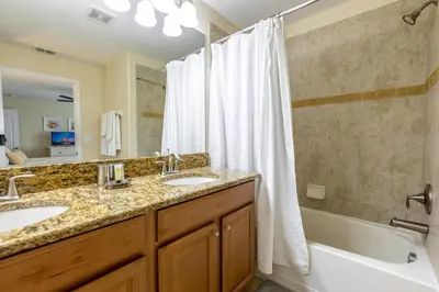 a bathroom with two sinks and a tub and a shower at Spetacular TownHome With Private Pool close to Disney 8919PP in Kissimmee