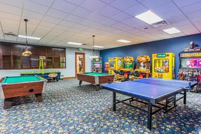 a gaming room with pool tables and arcade machines at Spetacular TownHome With Private Pool close to Disney 8919PP in Kissimmee