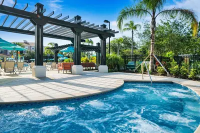 a swimming pool with a pergola and a swing at Vista Cay at Epic Universe - Standard 3 bedroom penthouse in Orlando
