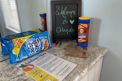 a counter top with snacks and a chalkboard with a sign at Cozy Tiny Home Near Disney World & Orlando Parks! in Kissimmee