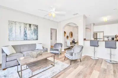 a living room with a couch and chairs and a table at Inviting 3BR Condo with Private Patio - Near Disney in Orlando
