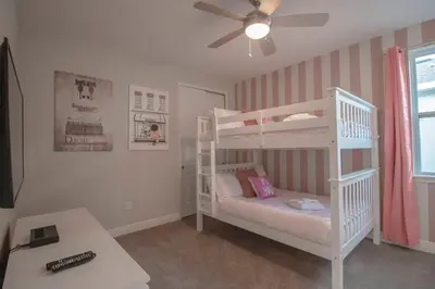 a white bunk bed in a room with a ceiling fan at Encore Resort 6 Bedroom Vacation Home with Pool (2102) in Orlando