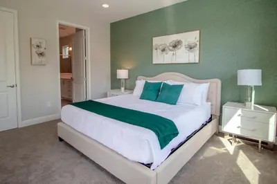 a bedroom with a large bed with green walls at Encore Resort 6 Bedroom Vacation Home with Pool (2102) in Orlando