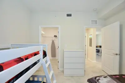 a bedroom with a bunk bed and a closet at Beautiful apartment in lux Storey Lake community 10 miles to Disney! in Kissimmee