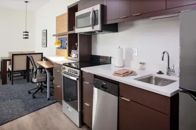 a kitchen with a sink and a counter top at TownePlace Suites by Marriott Orlando Airport in Orlando
