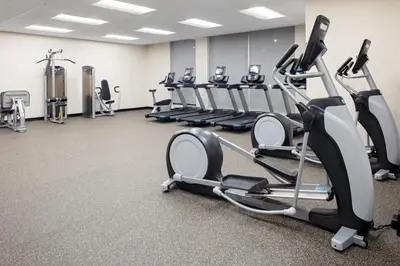 a gym with treadmills and elliptical machines at TownePlace Suites by Marriott Orlando Airport in Orlando