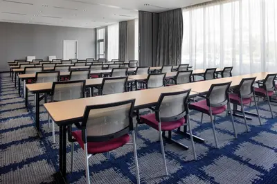 a room with rows of tables and chairs at TownePlace Suites by Marriott Orlando Airport in Orlando