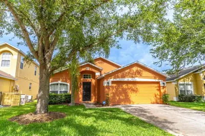 a house with a tree in front of a driveway at 17637 Silver Creek in Orlando