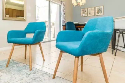 two blue chairs in a room with a table at Roomy Town Home, Mickey-Themed Bedroom! #4BV550 in Kissimmee