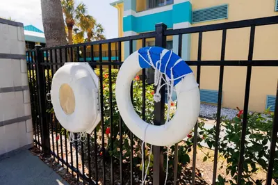a black fence with two lifesavers on it at Garnet Inn & Suites, Orlando in Orlando