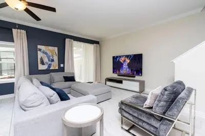 a living room with a couch and a tv at Stunning 5 Bd w/ Pool Close to Disney 2905 in Kissimmee