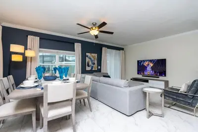 a living room with a couch and a dining room at Stunning 5 Bd w/ Pool Close to Disney 2905 in Kissimmee