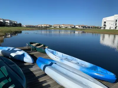 a group of boats parked on a dock in the water at 3B2B-Beautiful Lake View-Baby Friendly-FREE WATER PARK!NO Resort Fee-5 Miles to Disney-Storey Lake 3141 in Kissimmee