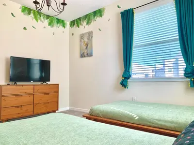 a bedroom with a bed and a tv and a window at 3B2B-Beautiful Lake View-Baby Friendly-FREE WATER PARK!NO Resort Fee-5 Miles to Disney-Storey Lake 3141 in Kissimmee