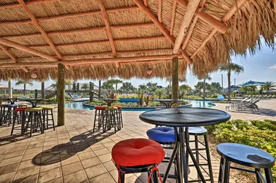 a patio with tables and chairs and a pool at 7 Mi Walt Disney World! Family Gem with Private Pool in Kissimmee