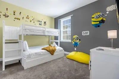a childs bedroom with a bunk bed and a yellow pillow at 371P Fabulous 8 BD Private PoolSpa- By Disney in Orlando