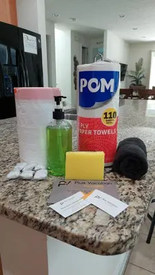a counter with a bottle of toilet paper and a bag of toiletries at 371P Fabulous 8 BD Private PoolSpa- By Disney in Orlando