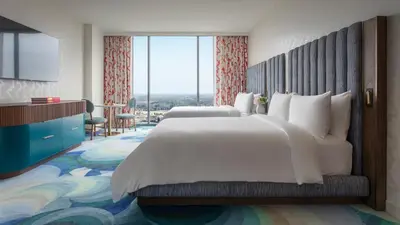 a hotel room with two beds and a large window at Lake Nona Wave Hotel in Orlando