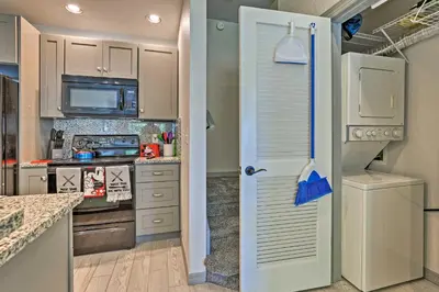 a kitchen with a white door and a refrigerator at 10 Mi to Disney Venetian Bay Villages Retreat in Kissimmee
