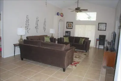 a living room with two brown couches at Luxury 5-Bed Villa, located only 3 miles from Disney World in Kissimmee