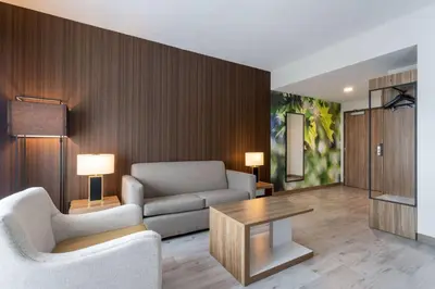 a living room with a couch and a table at Wyndham Garden Orlando Airport - Free Airport Shuttle in Orlando