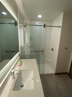 a bathroom with a sink and a shower at Wyndham Garden Orlando Airport - Free Airport Shuttle in Orlando