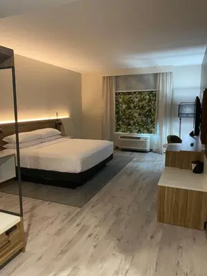 a hotel room with a bed and a window at Wyndham Garden Orlando Airport - Free Airport Shuttle in Orlando