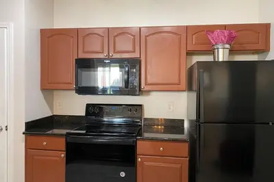 a kitchen with a black refrigerator and a microwave at LUXURY and VINTAGE space to enjoy your vacation!! in Kissimmee